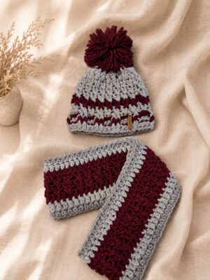 Handmade crochet winter hat and scarf set in red, grey and cream tones with pom-pom hat.