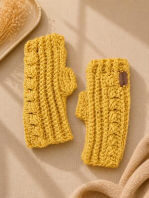 Handmade crochet fingerless gloves with textured honeycomb stitch in golden yellow yarn